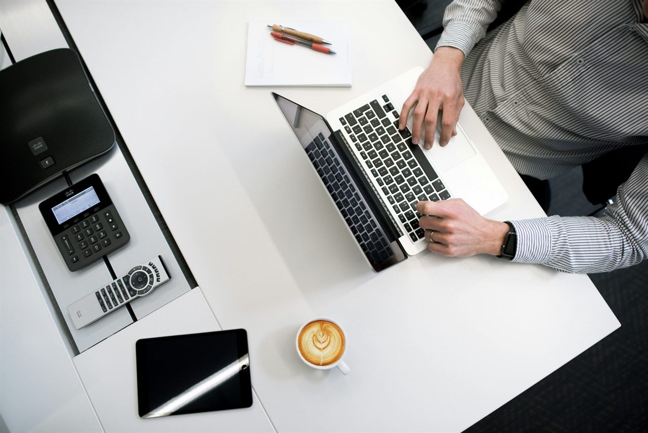 Arbeitsplatz mit Telefon und Laptop zur Planung von Abholung und Transport